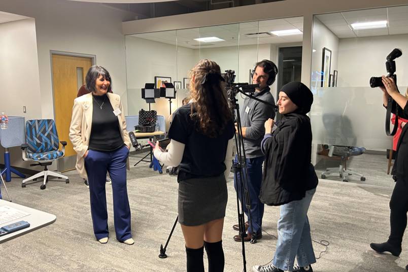 Students operate camera filming the GVSU president